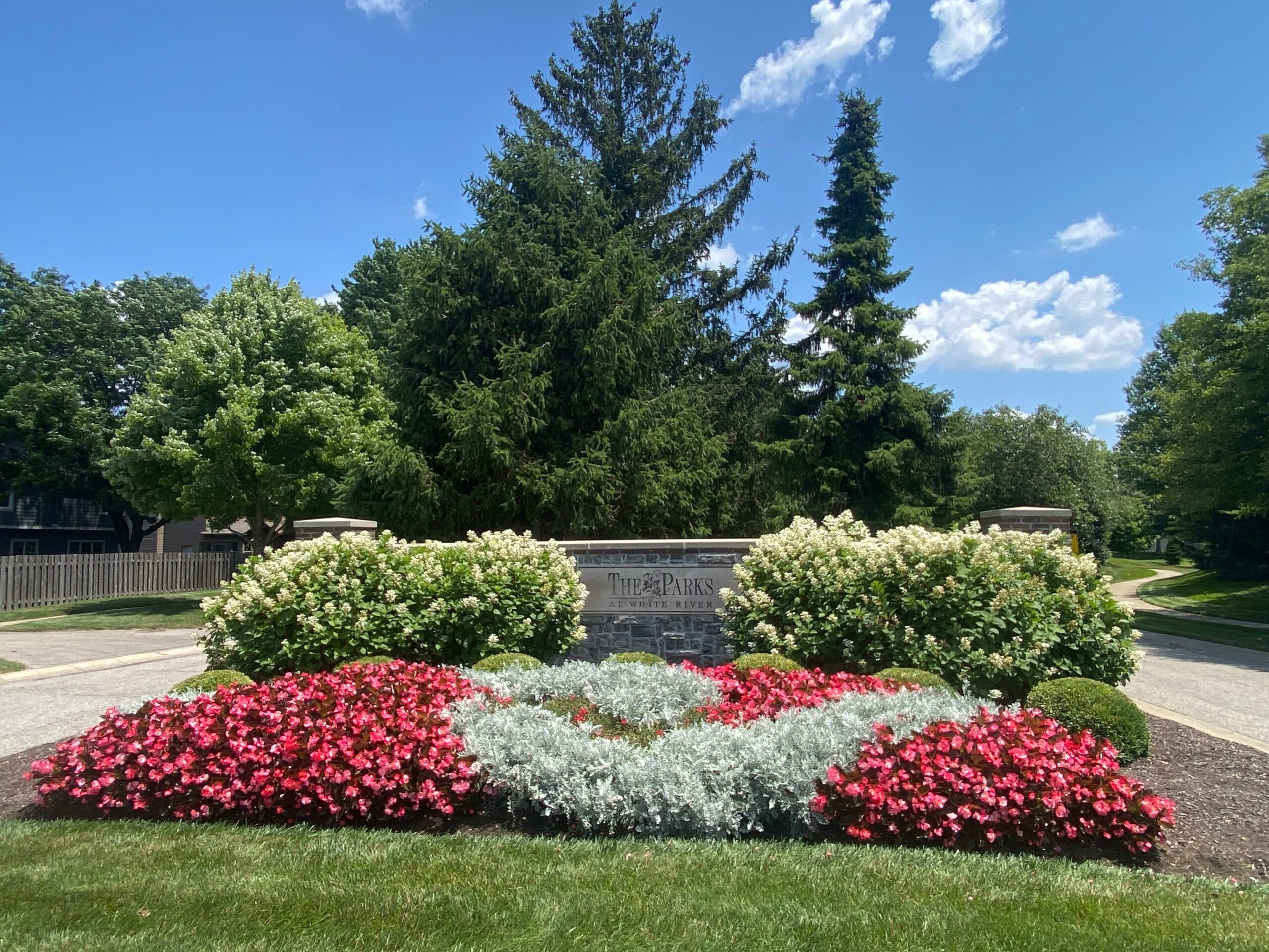 Landscaped garden entrance with flowering plants commercial