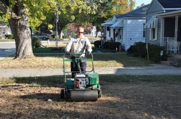 Lawn aeration machine plugging holes in residential turf