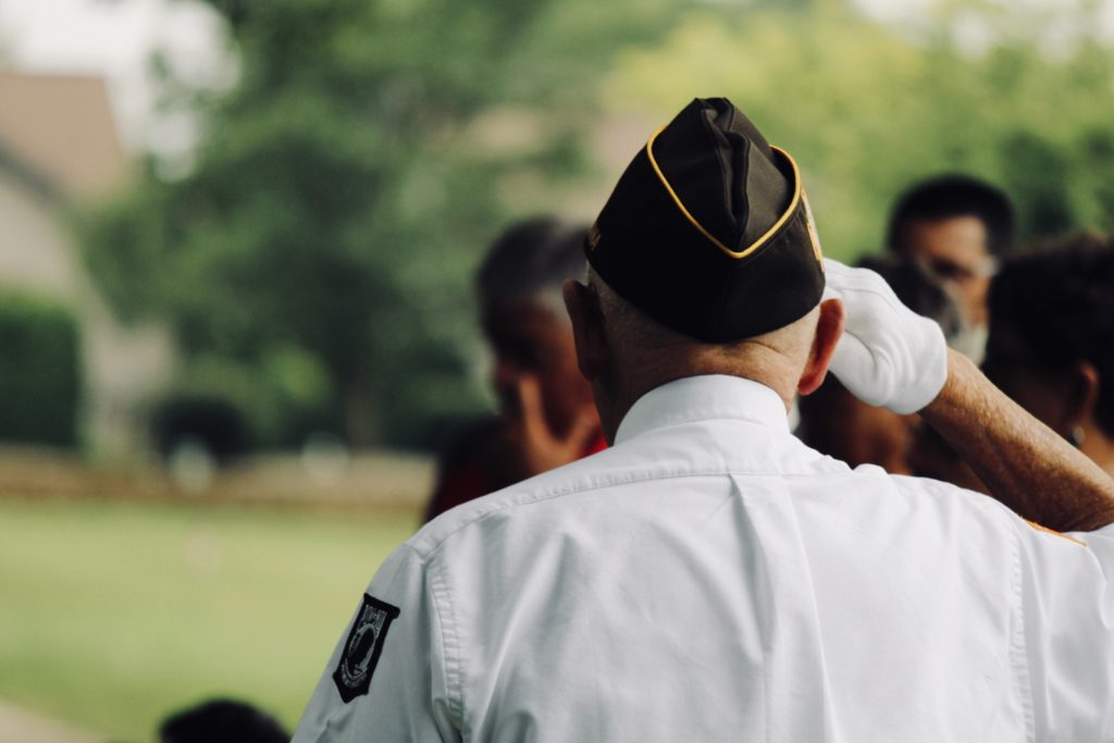 Veteran saluting at in uniform